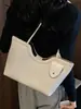 Bolsa de palha tecida da moda para mulheres, versão coreana de verão de 2026, elegante e texturizada, bolsa de ombro e de axila casual de grande capacidade