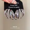 Pendientes irregulares de plata con incrustaciones de diamantes de estilo europeo y americano, modernos y versátiles para el uso diario, sensación de lujo ligero y alta gama, venta al por mayor