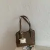 Bolsa de ombro retrô Shuai Mi Jia 2025 novo modelo início do outono cor sólida elegante única moderna tendência moda bolsa balde