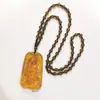Yiwu joyería al por mayor estilo étnico collar de gota de agua de cera de abeja sintética cadena larga de cuentas de madera para suéter colgante de ámbar sintético para mujer