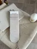 Calcetines holgados versátiles sin costuras para mujer, estilo coreano otoño e invierno para estudiantes, calcetines de media pantorrilla color blanco lechoso, calcetines largos de algodón de color liso para adolescentes