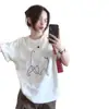 Camiseta de manga corta con estampado de gato a rayas blancas de seda de leche para hombre y mujer, nuevo estilo verano 2026, top holgado y casual de media manga