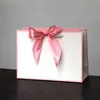 Bolsas de Papel con Moño de Regalo en Stock para Comercio Exterior y Compras Transfronterizas, Personalizables con Impresión de Logo, Envío Gratis