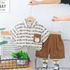 Nuevo Estilo de Verano 2025 Traje de Shorts Guapo de Manga Corta para Niños Conjunto de Dos Piezas Camisa con Estampado de Dibujos Animados Coreanos para Niños
