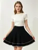 Venta al por mayor transfronteriza desde la fábrica de origen: falda corta de punto para mujer de cintura alta, línea A, con pliegues y bordado color block, estilo europeo y americano