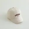Bordado de letras de dibujos animados para niños, cara sonriente, corto a lo largo de la gorra de béisbol, versión coreana de todo a juego para niños y niñas, bebé, gorra de béisbol para exteriores, venta al por mayor