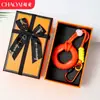 Chaveiro de anel de aperto criativo transfronteiriço para alívio de estresse, mini treinador de dedos colorido, dispositivo de aperto para alívio de estresse, pingente de mochila