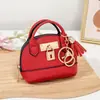Mini bolso de concha de celebridad de internet llavero bolso de mano monedero colgante de bolsa portátil para guardar labial auriculares bolsa pequeña