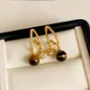 Brincos de olho de tigre e zircônia cúbica banhados a ouro 18k real, brincos estilo vintage com estética Melard, brincos leves e luxuosos, atacado