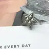 Suministro directo botón metálico de estrella de cinco puntas retro botón pequeño fragancia estilo europeo y americano suéter abrigo abrigo de cuero accesorios de joyería