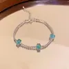 Pulseira Exquisita com Cristais Azuis e Diamantes Inlaid Leve Luxo High-End Sensação de Pulseira Temperamento Moda Versátil Nicho Design Sense Joia de Mão