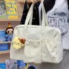 Bolsa de mano tipo tote coreana suave con cordón, fresca y dulce, perfecta para que las chicas jóvenes la lleven en sus salidas diarias y viajes de compras.