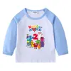 2026 Nova Camiseta Infantil Transfronteiriça Primavera e Outono Gola Redonda Desenho Animado Manga Longa Camisa Básica para Meninos e Meninas Camiseta de Algodão para Bebê