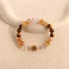 Pulsera bicolor de cristal azul natural y cristal rosa con diseño de oso y rosa, una pulsera blanca de lujo ligero y estilo antiguo fresco.