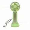 27 años Nuevo ventilador de mano pequeño Carga USB Viento fuerte de tres velocidades Batería de larga duración Correa base desmontable Portátil de escritorio