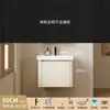 Tocador de baño engrosado y ahorrador de espacio con diseño en color crema, que cuenta con un lavabo redondeado, lavabo cerámico integrado y un lavabo de una sola pieza.