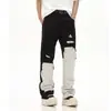 Jeans masculinos novos de corte reto, largos, rasgados, com blocos de cores preto e branco, estilo high street transfronteiriço americano