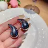 Pendientes colgantes de metal transfronterizos europeos y americanos para mujer, pendientes de estilo frío, diseño de nicho, pendientes personalizados de alta gama al por mayor