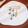 Broche de borla de ojo de diablo con incrustaciones de diamantes, estilo creativo europeo y americano, con sentido avanzado, ojos azules, suéter de cintura ajustada, broche de viento frío