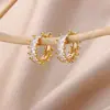 Pendientes de Oro de 18K Elegantes Transfronterizos Lujo Accesible Europeos y Americanos de Gama Alta Versátiles Simples para Piercing de Oreja para Mujeres Fabricante Mayorista