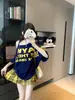 Camiseta de Tirantes con Estampado de Letras y Hombros Descubiertos de Manga Corta para Mujer Verano Diseño Americano Holgado Sexy Top Versátil de Media Manga