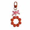 Llavero Colgante de Coche con Lazo de Perlas Electrochapado Color Caramelo Pintura para Hornear Hebilla Pequeña para Puerta Accesorios de Perla Bolsa