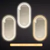 Espejo de baño inteligente ovalado para pared salón de belleza con luz pantalla táctil LED inducción antivaho espejo de tocador HD