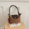 Bolsa de axila nicho transfronteiriça estilo francês para mulheres, nova moda bolsa de ombro tipo bolinho de massa camurça para o dia a dia, bolsa de ombro e transversal casual