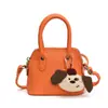 Bolso de Hombro para Niña Color Sólido Estilo Coreano Colgante de Cachorro de Dibujos Animados Bolso de Mano para Bebé Nuevo Mini Bolso Infantil