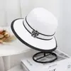 Sombrero de paja tipo pescador elegante estilo Hepburn con flor de camelia para salidas de primavera y verano, sombrero de protección solar y parasol para mujer, ropa casual