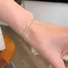 Pulsera de hueso de serpiente con cuentas plateadas de doble capa, estilo minimalista coreano, versátil para el uso diario, exquisitamente diseñada y con un toque sofisticado y de alta gama; venta al por mayor de cadenas delicadas