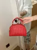 Bolso tejido de lujo ligero de estilo coreano de nicho para mujer, bolso casual tipo concha para el verano 2026, bolso de hombro y cruzado de alta gama