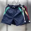 Shorts casuales de verano para hombres y mujeres, marca de moda ins holgados casuales de moda pantalones de longitud media, pantalones versátiles de estilo coreano de cinco puntos