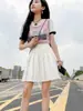 En stock falda mini plisada de cintura alta para mujer, media falda, estilo académico, versión coreana, color liso, falda anti-exposición, elástico en la cintura trasera