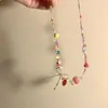 Collar de cuentas de color dulce "Burbuja de Fresa" con diseño de nicho de verano y lazo con corazón rojo.