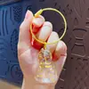 Cápsula de Almacenamiento de Pelo de Gato Azul Transparente Colgante Gashapon Caja de Almacenamiento de Pelo de Gato Colgante de Llavero Recolección de Pelo de Gato