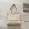 Bolsa de plumón de gran capacidad estilo simple para mujer 2026 Nueva moda Bordado de hilo de nailon Bolso de mano acolchado de algodón Bolsa de mano para estudiante