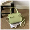 Tendencia de Moda Primavera 2026 Nuevo Viaje Simple Temperamento Decoración de Cinturón de Moda Bolso Cruzado de un Hombro Portátil para Mujer