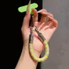 Correa de anillo superestilosa con bloques de color, duradera y resistente con un gancho de metal, un cordón para teléfono anti-pérdida para mujer para ir de compras