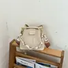 Bolso cubo muy elegante, nuevo bolso cruzado de moda otoño 2026, cadena de nicho sensación relajada bolso de mano de color liso