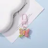 Llavero colgante de resina de color caramelo simulación de mariposa DIY accesorio de llave con cuentas de dibujos animados decoración creativa para bolsa