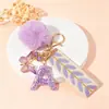 Suministra y Vende Llaveros con Alfabeto de 26 Letras con Lentejuelas Moradas, Llaveros de Pompones de Mariposa, Dijes para Bolsos de Mujer