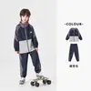 Conjunto Esportivo Infantil Duoduo 2026 Primavera e Outono Novo Jaqueta Infantil Masculina Color Block Estampada e Calça de Moletom Tendência