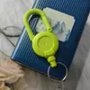 Atacado de fábrica pode colar cola logo fivela de puxar fácil cor sólida mochila de macaron chaveiro corda de arame exterior puxar fácil