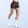 Shorts de yoga sin costuras cruzados en la cintura para mujer, adecuados para correr y fitness, con características de realce de glúteos y control de abdomen, shorts de tres cuartos de secado rápido y transpirables de efecto "pompa de durazno"