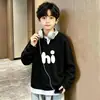 Camiseta de manga larga de dos piezas falsas para niño 2026 primavera/otoño estilo coreano top gofrado elegante casual versátil camiseta básica de moda
