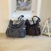 Bolsas Femininas Novas Outono/Inverno 2026 Bolsas de Ombro Casuais Retrô Bolsas Dumpling Design de Nicho Bolsas Transversais da Moda