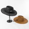 Moda casual nueva de primavera y verano tejida a mano con cuerda de amarre paja de papel hueca anillo alto superior ala grande sombrero de paja sombrero de sol para exteriores
