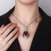Otoño e invierno nuevo Zhuang Shengsheng joyería cobre chapado en oro simulación corindón rojo retro gota de agua personalidad colgante femenino 13*18