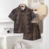 Suministro Exclusivo Transfronterizo de Nuevo Conjunto de Camisa de Manga Corta con Estampado Geométrico para Niños Estilo Verano, Conjunto de Dos Piezas de Moda Coreana para Niños